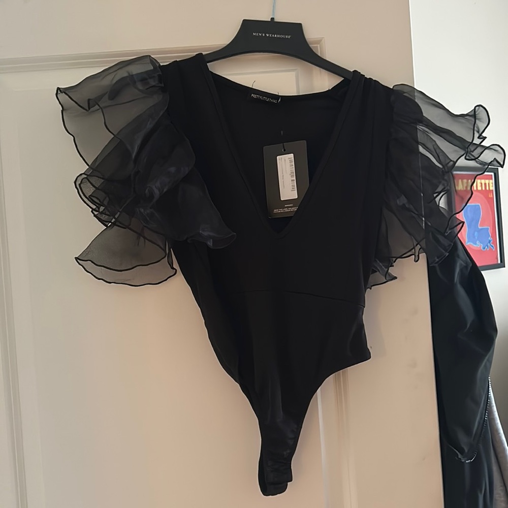 Black bodysuit with ruffle sleeve! NEVER WORN!